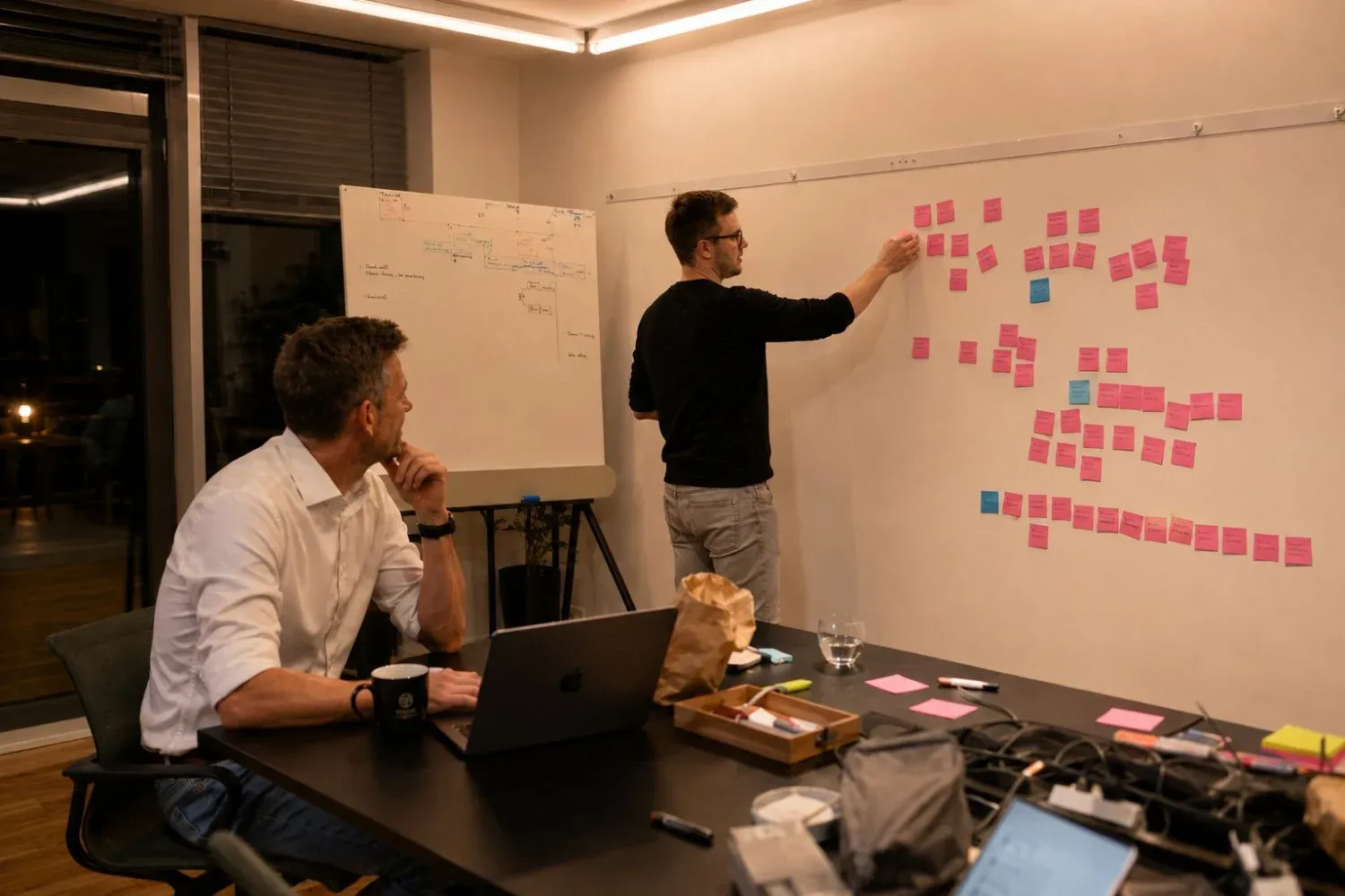Tim Schulte and Samson Groß working through a product map on the whiteboard